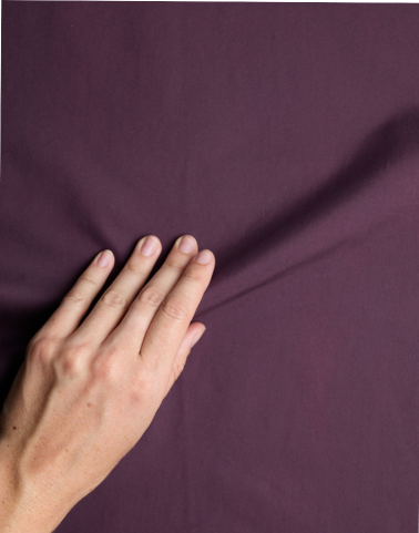 Neatly folded surplus fabrics at Circular Sourcing, showcasing unique textures and colours